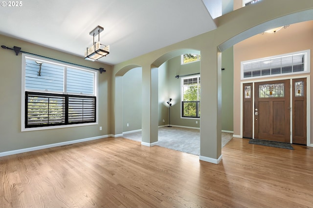 3140 Sabo Ln, West Linn, OR 97068 - entryway with light wood-type flooring, arched walkways, and baseboards