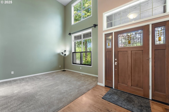 3140 Sabo Ln, West Linn, OR 97068 - foyer entrance featuring healthy amount of natural light, baseboards, carpet floors, a high ceiling, and wood finished floors