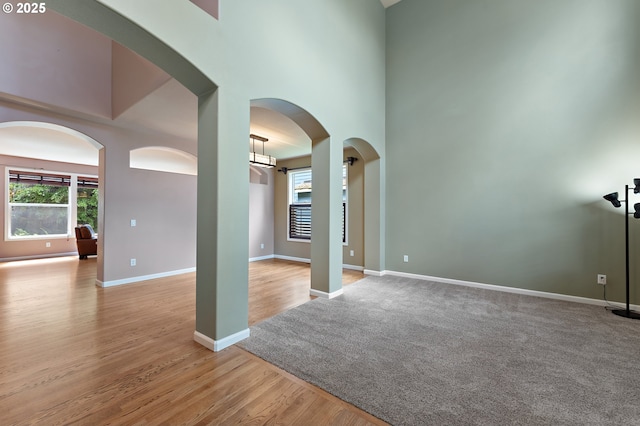 3140 Sabo Ln, West Linn, OR 97068 - spare room featuring wood finished floors, a high ceiling, and baseboards