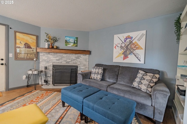 living area with wood finished floors, a fireplace, and a textured ceiling