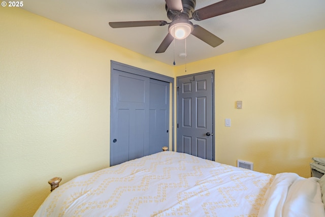 bedroom featuring a closet, visible vents, and a ceiling fan