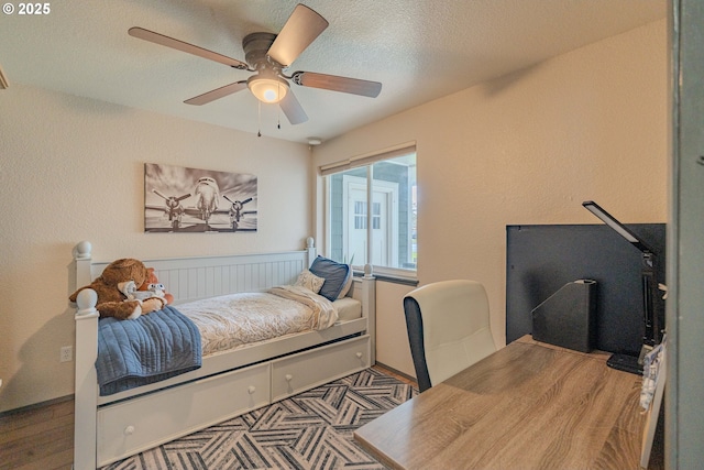 bedroom with a textured ceiling and ceiling fan