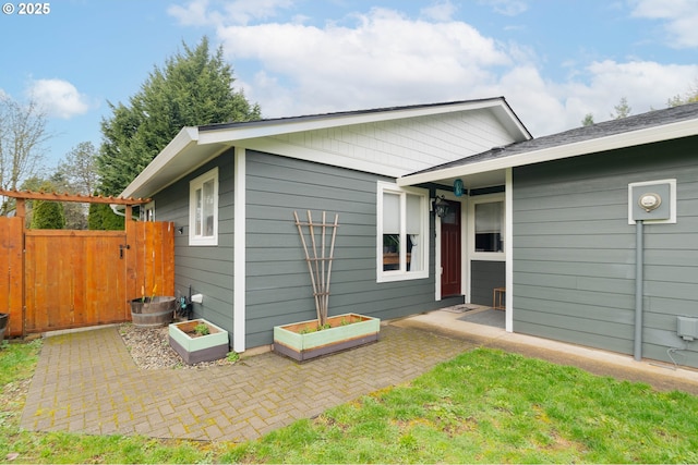 exterior space with a garden, a gate, a patio area, and fence