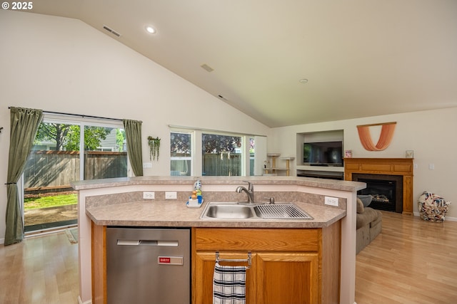 5419 Baden Way, Eugene, OR 97402 - kitchen featuring dishwasher, open floor plan, high vaulted ceiling, light wood-style flooring, and a center island with sink