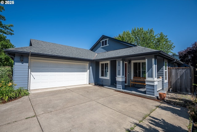5419 Baden Way, Eugene, OR 97402 - view of front facade featuring driveway, covered porch, a shingled roof, and a garage