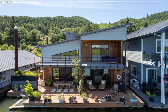 23586 NW St Helens Rd Unit U12, Portland, OR 97231 - rear view of property featuring a wooded view, a balcony, and a deck
