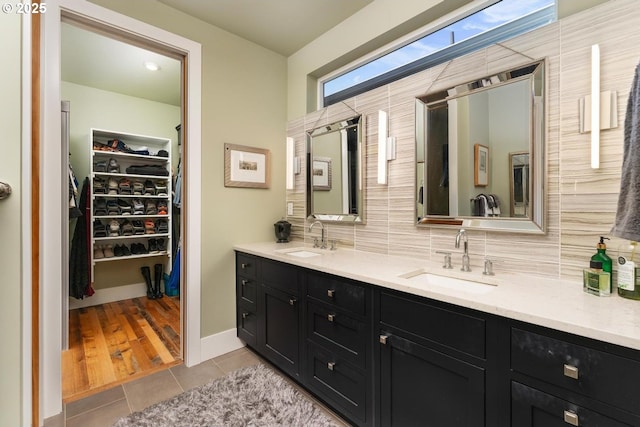 23586 NW St Helens Rd Unit U12, Portland, OR 97231 - bathroom featuring tile patterned flooring, double vanity, decorative backsplash, and a spacious closet