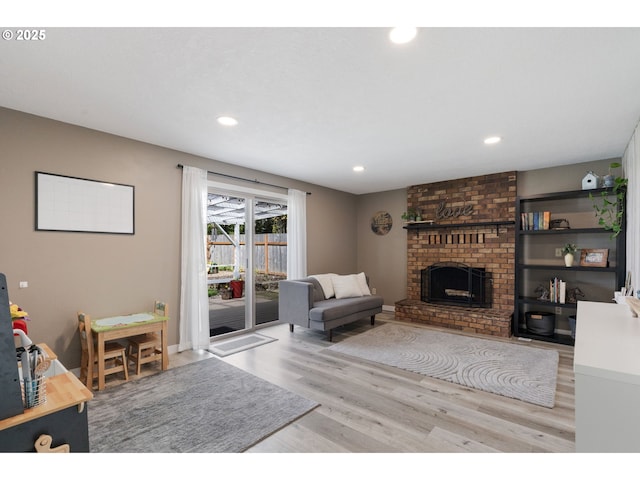 living area with recessed lighting, wood finished floors, and a fireplace