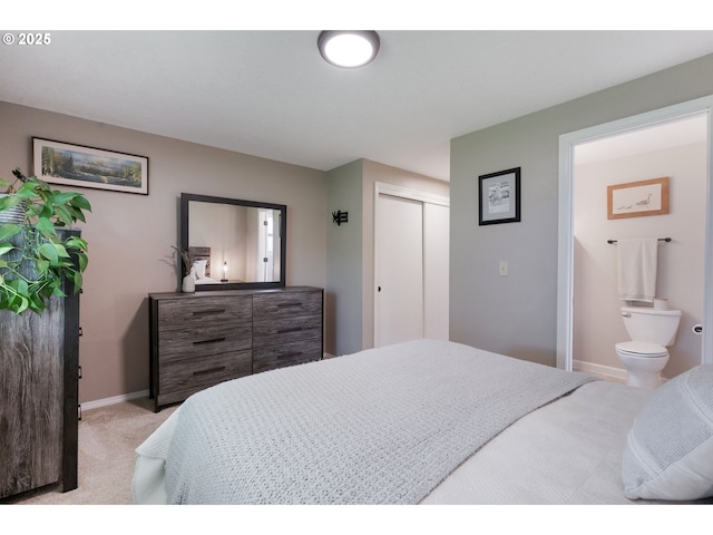 bedroom with light colored carpet, baseboards, and a closet