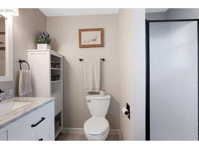bathroom featuring tile patterned flooring, vanity, toilet, baseboards, and a shower stall