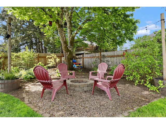 view of patio featuring a fenced backyard and an outdoor fire pit