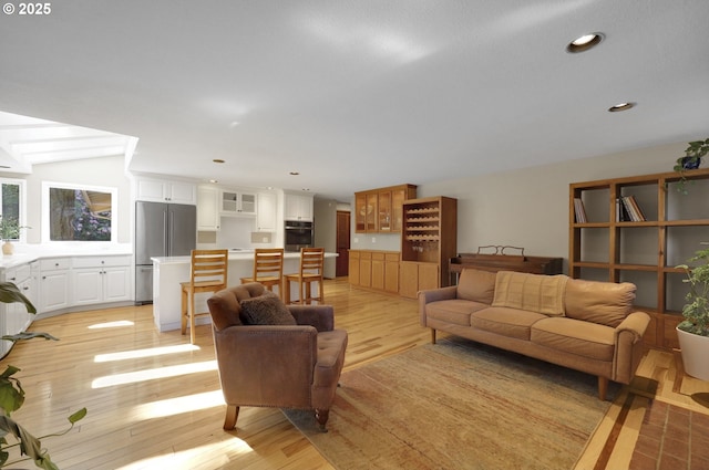 living area with recessed lighting and light wood-style floors