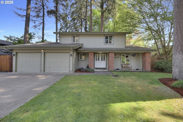 traditional-style house featuring an attached garage, fence, driveway, and a front yard