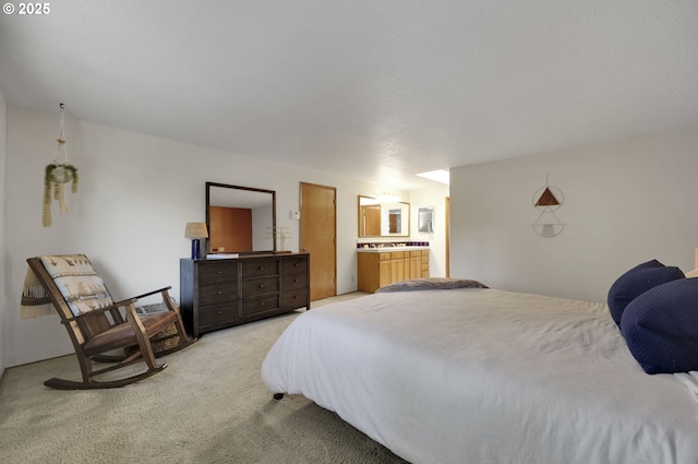 bedroom featuring ensuite bathroom and light carpet
