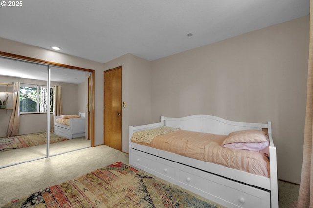 carpeted bedroom with recessed lighting and a closet