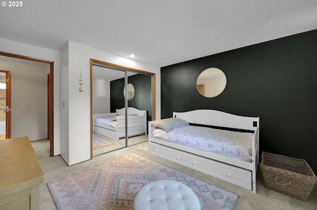 carpeted bedroom featuring a closet and recessed lighting