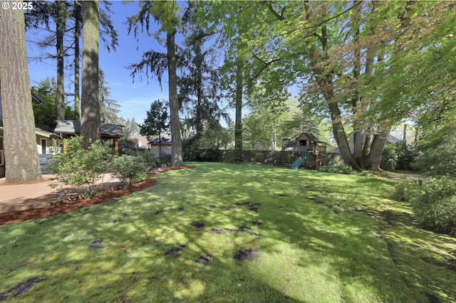 view of yard featuring a playground and fence