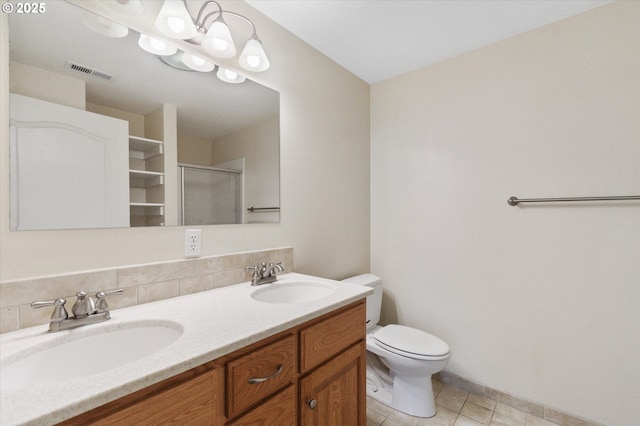 bathroom with backsplash, an enclosed shower, vanity, tile patterned flooring, and toilet