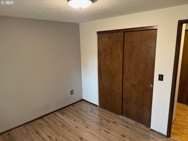18622 SE Stephens Cir, Portland, OR 97233 - unfurnished bedroom with light wood-style flooring and a closet