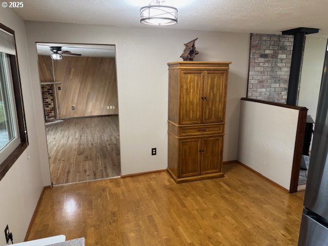 18622 SE Stephens Cir, Portland, OR 97233 - unfurnished dining area featuring light wood-style floors, ceiling fan, and a textured ceiling