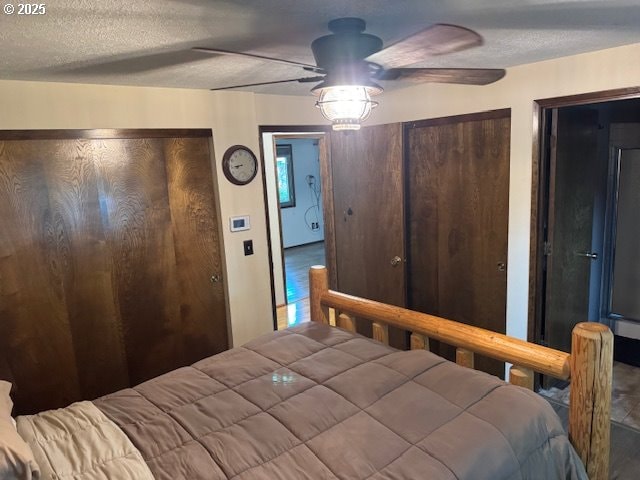 18622 SE Stephens Cir, Portland, OR 97233 - bedroom with wood finished floors, a textured ceiling, multiple closets, and ceiling fan