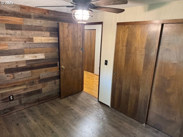 18622 SE Stephens Cir, Portland, OR 97233 - unfurnished bedroom with wood finished floors, wood walls, and a ceiling fan