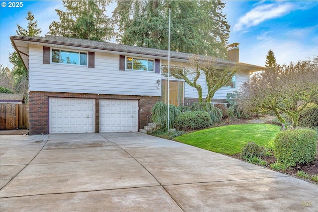 bi-level home with a front lawn and a garage