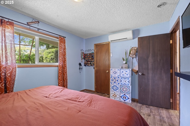 8015 NE 90th Ave, Vancouver, WA 98662 - bedroom featuring a wall unit AC, a textured ceiling, and wood finished floors