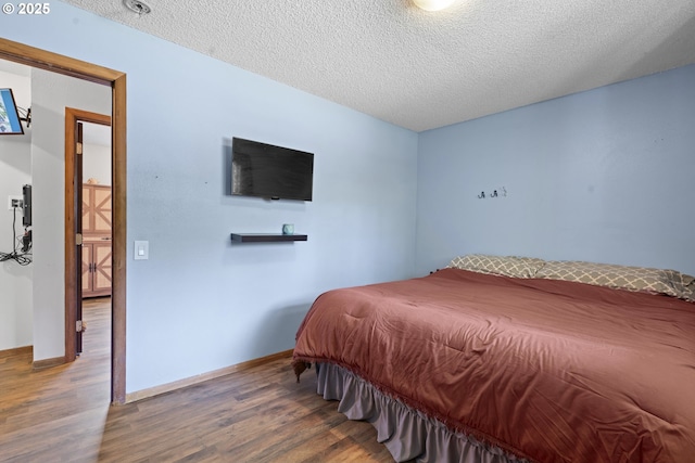 8015 NE 90th Ave, Vancouver, WA 98662 - bedroom with wood finished floors, a textured ceiling, and baseboards