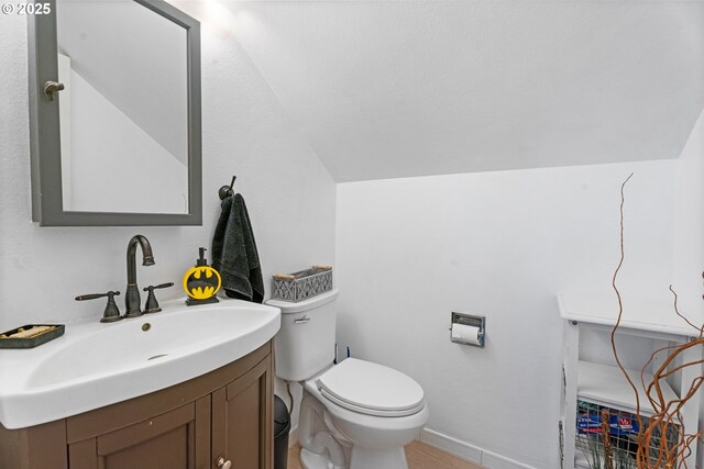 8015 NE 90th Ave, Vancouver, WA 98662 - half bathroom with lofted ceiling, vanity, toilet, and baseboards