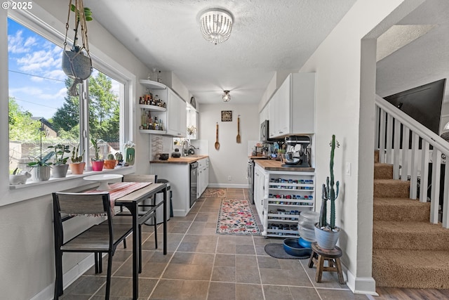 8015 NE 90th Ave, Vancouver, WA 98662 - kitchen featuring open shelves, a textured ceiling, white cabinets, butcher block counters, and stainless steel appliances