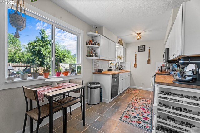 8015 NE 90th Ave, Vancouver, WA 98662 - kitchen featuring wooden counters, dishwasher, open shelves, white cabinets, and a textured ceiling