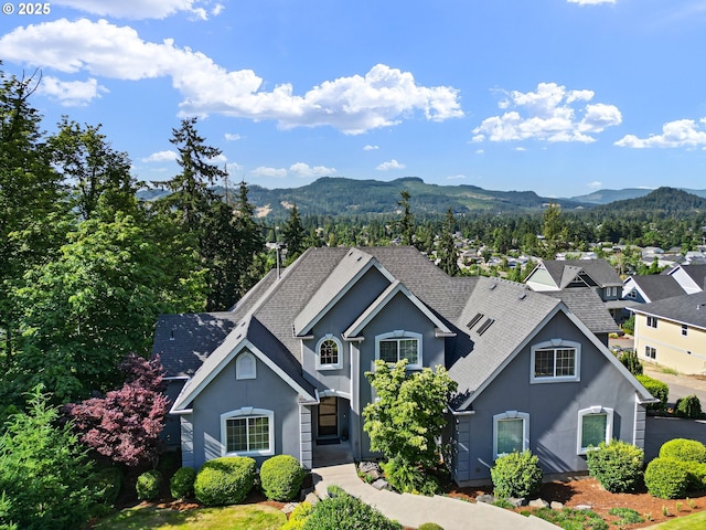 380 Mountaingate Dr, Springfield, OR 97478 - traditional-style house with a mountain view, roof with shingles, and stucco siding