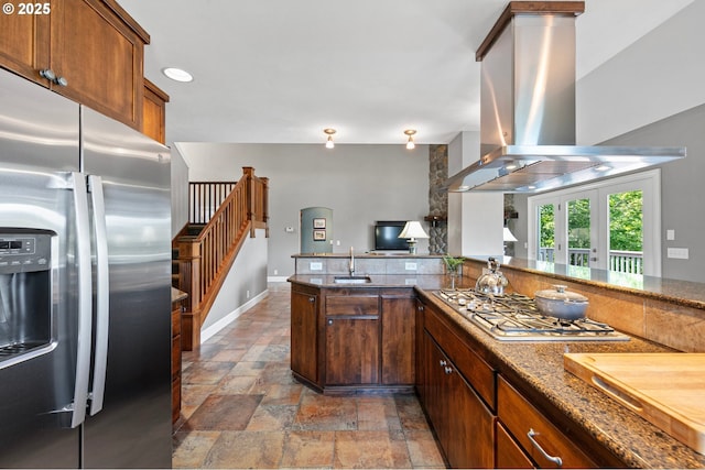 380 Mountaingate Dr, Springfield, OR 97478 - kitchen with appliances with stainless steel finishes, island range hood, stone tile flooring, french doors, and dark stone countertops