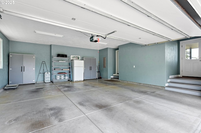 380 Mountaingate Dr, Springfield, OR 97478 - garage featuring freestanding refrigerator, electric panel, and a garage door opener