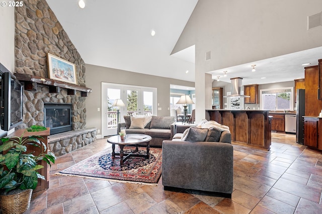 380 Mountaingate Dr, Springfield, OR 97478 - living room with high vaulted ceiling, a stone fireplace, plenty of natural light, and stone tile floors