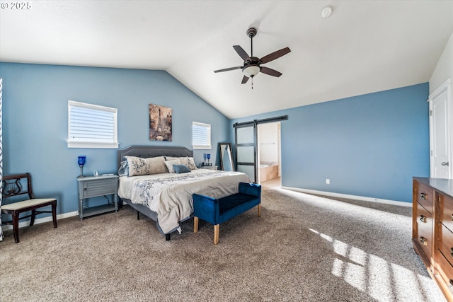 bedroom featuring vaulted ceiling, carpet flooring, ceiling fan, a barn door, and ensuite bath