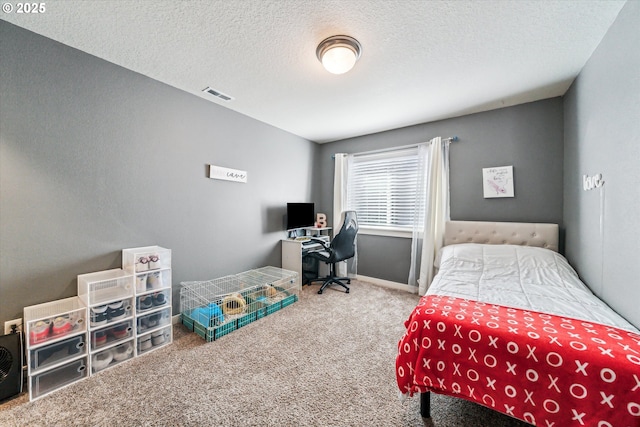 bedroom with carpet and a textured ceiling