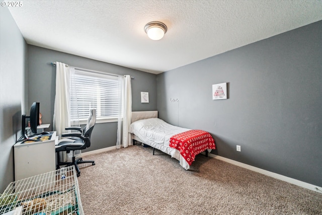 bedroom featuring carpet flooring and a textured ceiling