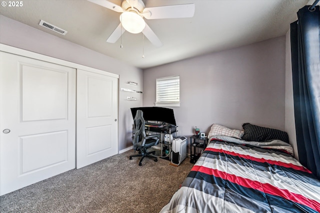 bedroom featuring ceiling fan, a closet, and dark colored carpet