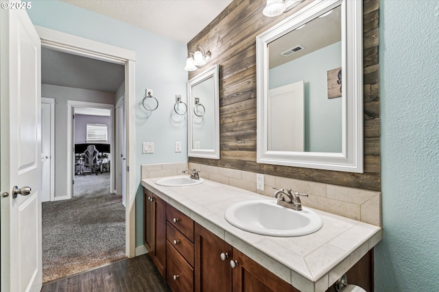 bathroom featuring vanity, backsplash, and wood-type flooring