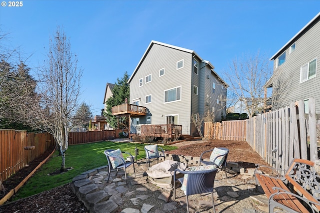 back of property featuring a deck, a patio, and a lawn