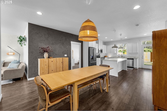 dining area with recessed lighting, baseboards, and dark wood-style floors
