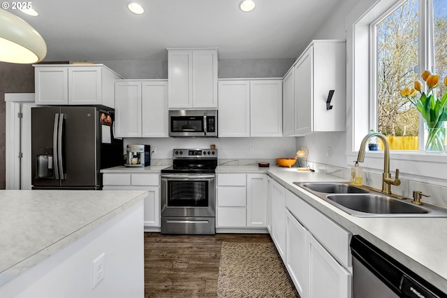 kitchen with recessed lighting, plenty of natural light, appliances with stainless steel finishes, and a sink
