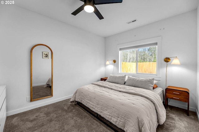 bedroom featuring baseboards, a ceiling fan, visible vents, and carpet