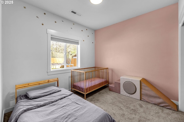 carpeted bedroom featuring visible vents