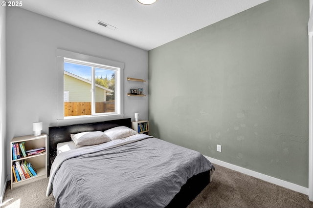 carpeted bedroom featuring baseboards and visible vents