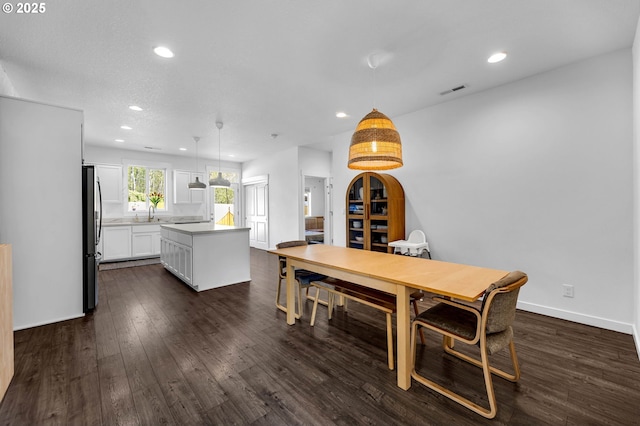 dining area with baseboards, dark wood-style floors, and recessed lighting