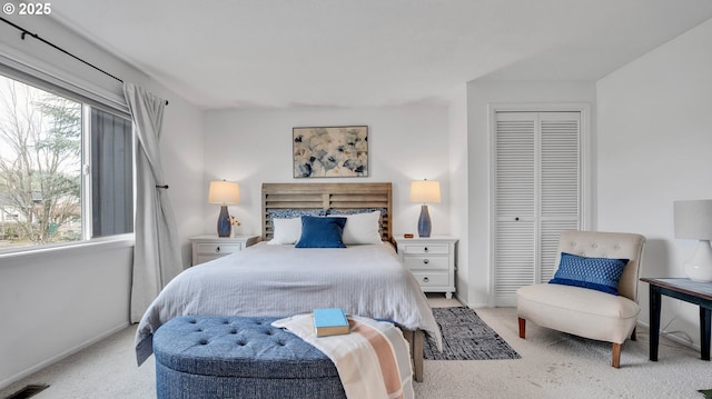 carpeted bedroom featuring baseboards, multiple windows, visible vents, and a closet