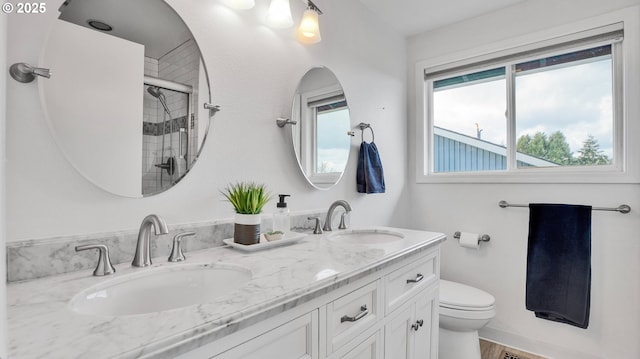 bathroom featuring toilet, plenty of natural light, and a sink